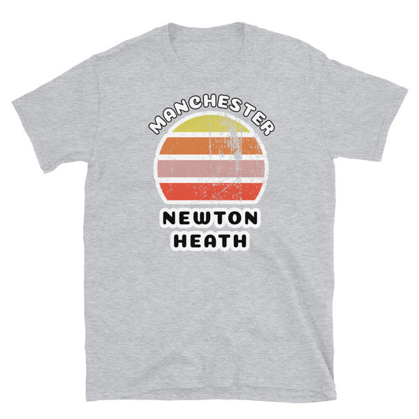 Distressed style abstract retro sunset graphic in yellow, orange, pink and scarlet stripes. The name of Manchester is displayed at the top wrapped around the sunset. Below the retro sunset design is the famous Manchester place name of Newton Heath on this light grey cotton t-shirt.