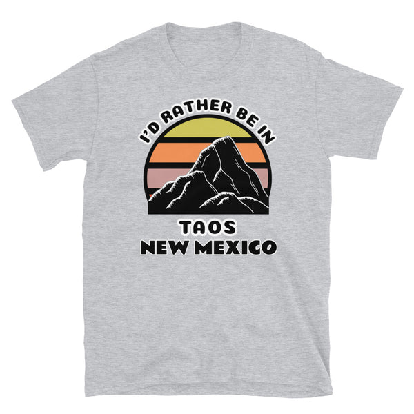 Taos New Mexico vintage sunset mountain scene in silhouette, surrounded by the words I'd Rather Be In on top and Taos New Mexico below on this light grey cotton t-shirt