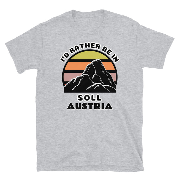 Söll Austria vintage sunset mountain scene in silhouette, surrounded by the words I'd Rather Be In on top and Söll, Austria below on this light grey cotton ski and mountain themed t-shirt
