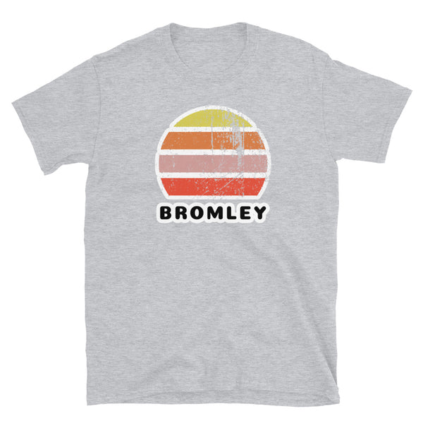 Vintage distressed style retro sunset in yellow, orange, pink and scarlet with the name Bromley beneath on this light grey cotton t-shirt