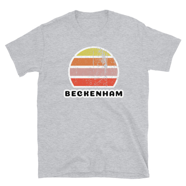 Vintage distressed style retro sunset in yellow, orange, pink and scarlet with the London neighbourhood of Beckenham beneath on this light grey cotton t-shirt