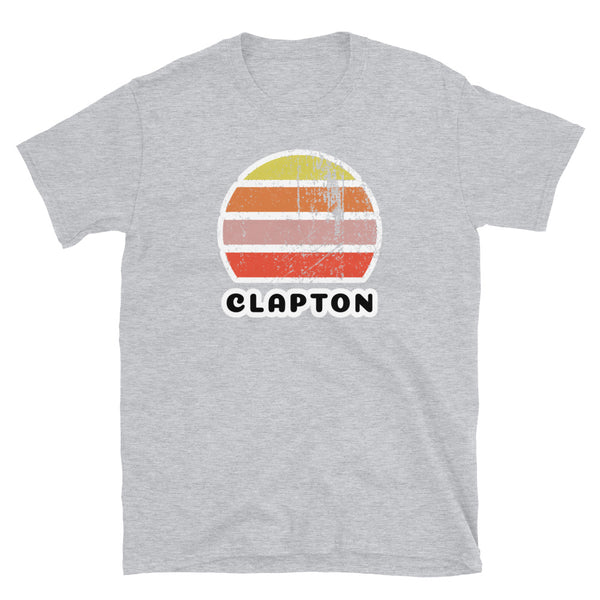 Vintage distressed style retro sunset in yellow, orange, pink and scarlet with the London neighbourhood of Clapton beneath on this light grey cotton t-shirt