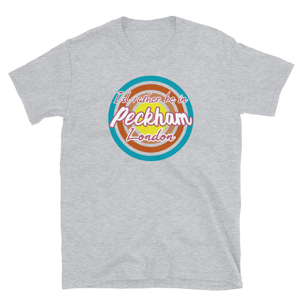 Urban vintage style graphic in turquoise, orange, pink and yellow concentric circles with the slogan I'd rather be in Peckham London across the front in retro style font on this light grey cotton t-shirt