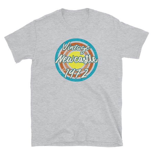Vintage Newcastle Est. 1972 retro vintage grunge style design in turquoise, orange, pink and yellow tones for birthday gift ideas on this light grey cotton t-shirt