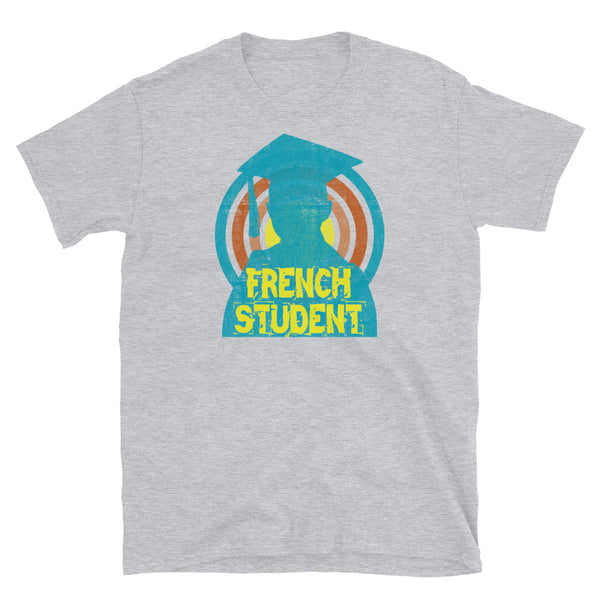 French Student novelty tee with a distressed style turquoise silhouetted student against a concentric circular design and the words French Student in bold yellow font on this light grey cotton fun graphic t-shirt by BillingtonPix