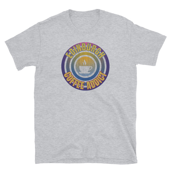 Concentric circular design of retro 80s metallic colours and the slogan Edinburgh Coffee Addict with a coffee cup silhouette in the centre. Distressed and dirty style image for a vintage Retrowave look on this light grey cotton t-shirt by BillingtonPix