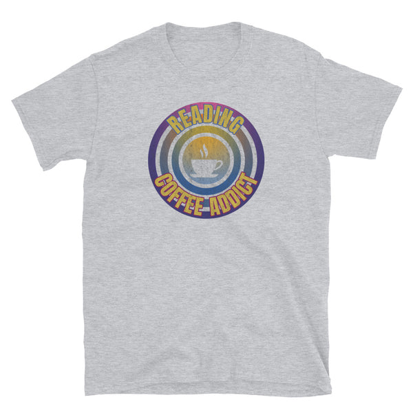 Concentric circular design of retro 80s metallic colours and the slogan Reading Coffee Addict with a coffee cup silhouette in the centre. Distressed and dirty style image for a vintage Retrowave look on this light grey cotton t-shirt by BillingtonPix