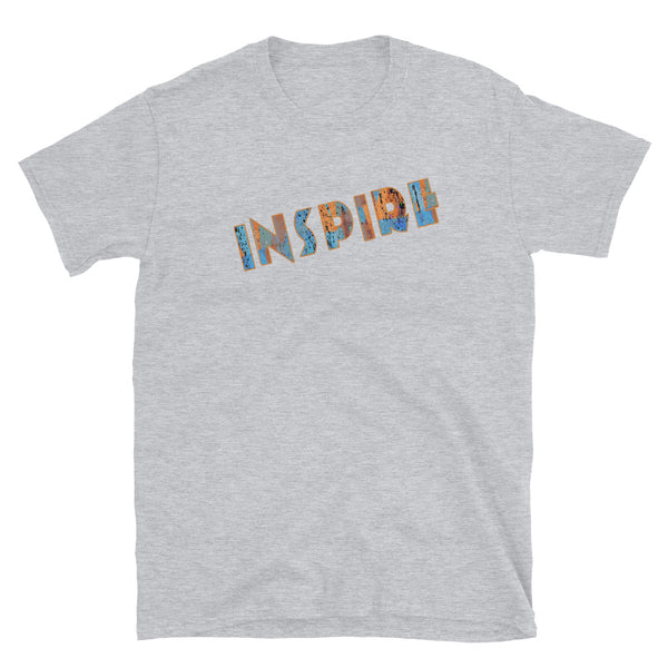 Inspirational slogan graphic t-shirt with the single word Inspire filled with vintage pattern burnt orange, turquoise blue and taupe tones and displayed on this light grey cotton t-shirt by BillingtonPix in an energetic diagonal slant 