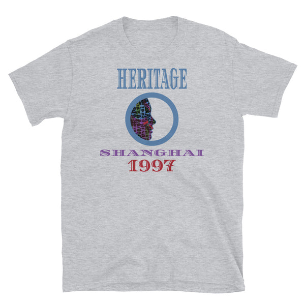 Graphic t-shirt with a patterned profile face in abstract design, tones of blue, green, purple, red, in circular format, with the words Heritage Shanghai 1997 in blue, purple and red on this light grey cotton t-shirt by BillingtonPix