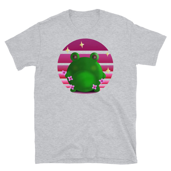 Grumpy green frog stands in front of a pink / purple vintage sunset with blossom and stars on this light grey cotton graphic t shirt by BillingtonPix 