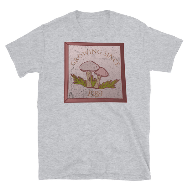 Growing since 1989 cute Goblincore style design with two mushrooms in muted tones and a glass framed effect with distressed look on this sport grey cotton t-shirt by BillingtonPix