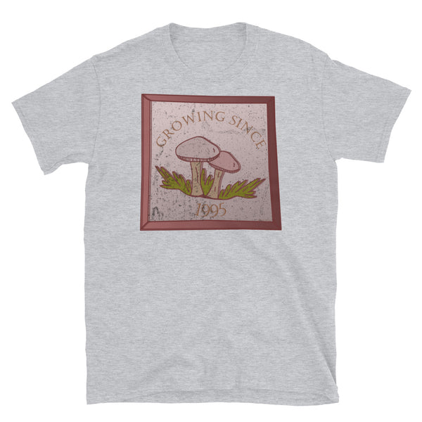 Growing since 1995 cute Goblincore style design with two mushrooms in muted tones and a glass framed effect with distressed look on this sport grey cotton t-shirt by BillingtonPix