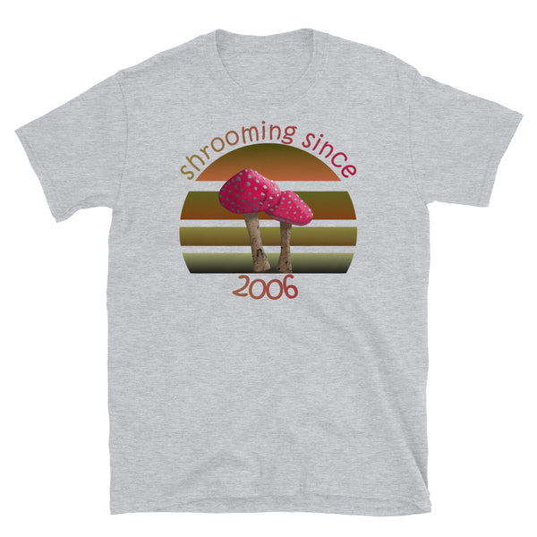 Shrooming since 2006 cute Goblincore style design with two red fly agaric mushrooms with distressed look against a multi-toned nature colour palette abstract vintage sunset design on this sport grey cotton t-shirt by BillingtonPix