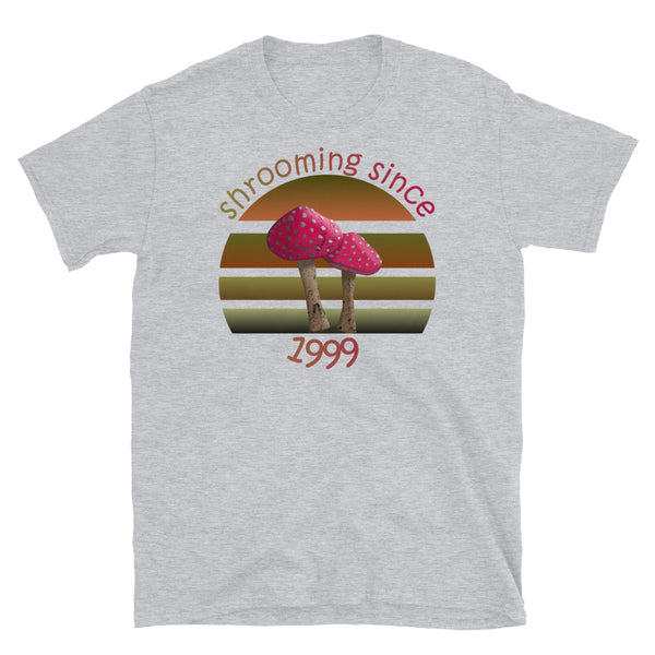 Shrooming since 1999 cute Goblincore style design with two red fly agaric mushrooms with distressed look against a multi-toned nature colour palette abstract vintage sunset design on this sport grey cotton t-shirt by BillingtonPix