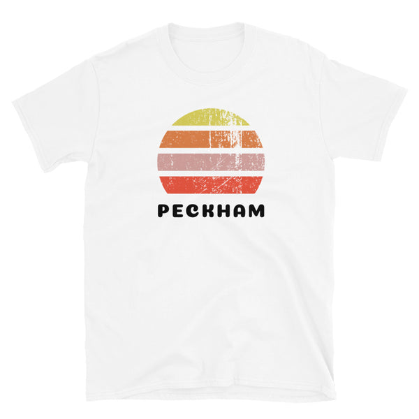 Vintage retro sunset in yellow, orange, pink and scarlet with the name Peckham beneath on this white t-shirt