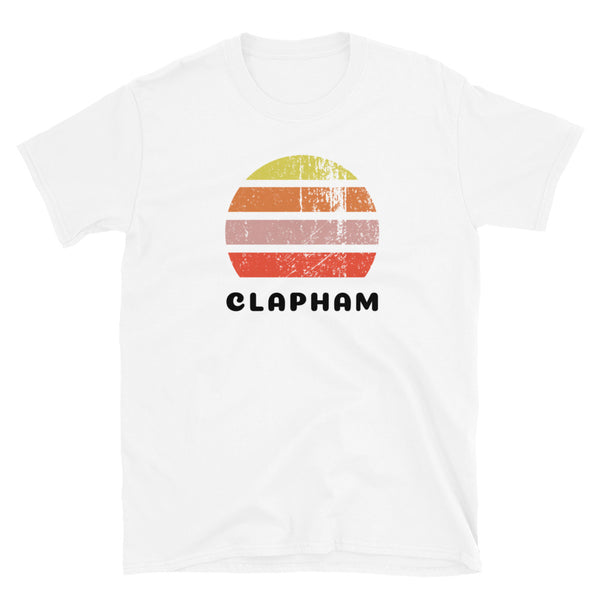 Vintage retro sunset in yellow, orange, pink and scarlet with the name Clapham beneath on this white t-shirt