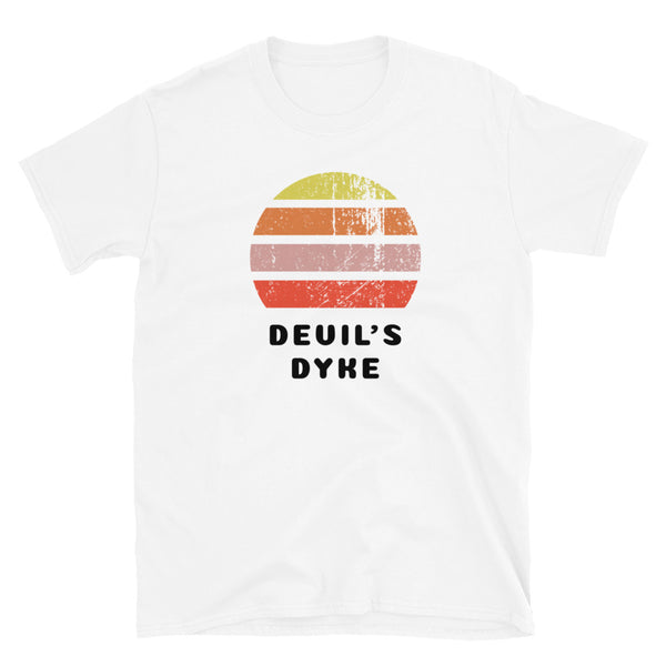 Features a distressed abstract retro sunset graphic in yellow, orange, pink and scarlet stripes rising up from the famous Devil's Dyke place name in Brighton on this white t-shirt