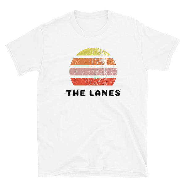 Distressed style abstract retro sunset graphic in yellow, orange, pink and scarlet stripes rising up from the famous Brighton place name, The Lanes on this white cotton t-shirt