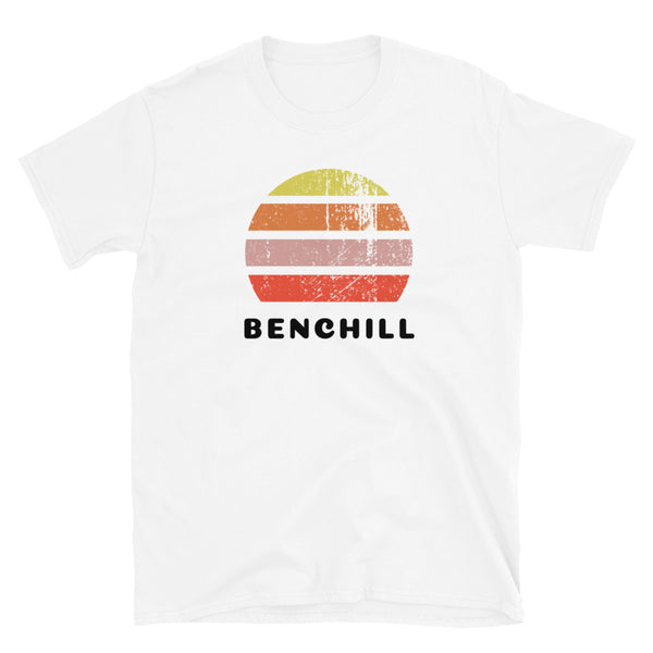 Distressed style abstract retro sunset graphic in yellow, orange, pink and scarlet stripes above the famous Manchester place name of Benchill on this white cotton t-shirt