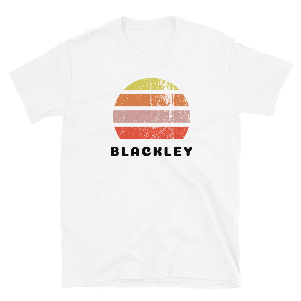 Distressed style abstract retro sunset graphic in yellow, orange, pink and scarlet stripes above the famous Manchester place name of Blackley on this white cotton t-shirt