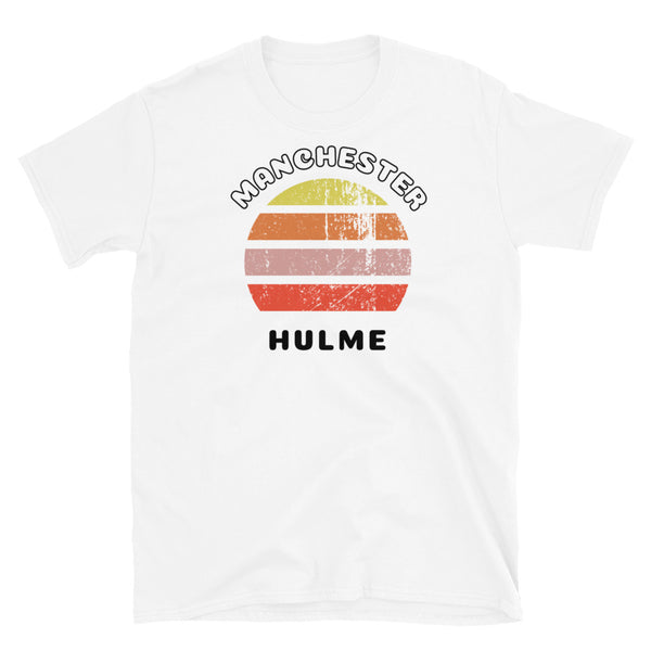 Distressed style abstract retro sunset graphic in yellow, orange, pink and scarlet stripes. The name of Manchester is displayed at the top wrapped around the sunset. Below the retro sunset design is the famous Manchester place name of Hulme on this white cotton t-shirt.