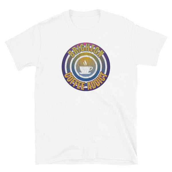Concentric circular design of retro 80s metallic colours and the slogan Brighton Coffee Addict with a coffee cup silhouette in the centre. Distressed and dirty style image for a vintage Retrowave look on this white cotton t-shirt by BillingtonPix