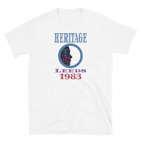 Graphic t-shirt with a patterned profile face in abstract design, tones of blue, green, purple, red, in circular format, with the words Heritage Leeds 1983 in blue, purple and red on this white cotton t-shirt by BillingtonPix