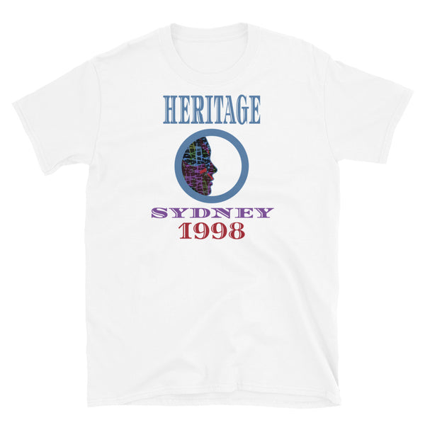Graphic t-shirt with a patterned profile face in abstract design, tones of blue, green, purple, red, in circular format, with the words Heritage Sydney 1998 in blue, purple and red on this white cotton t-shirt by BillingtonPix