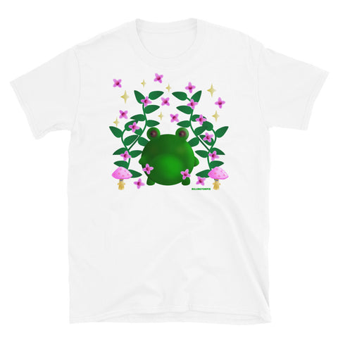 Cute kawaii green frog in this Cottagecore asesthetic graphic design. Features green leaves, pink blossom, grumpy mushrooms and stars in the sky on this white cotton t-shirt by BillingtonPix