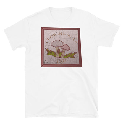 Growing since 1997 cute Goblincore style design with two mushrooms in muted tones and a glass framed effect with distressed look on this white cotton t-shirt by BillingtonPix